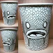 paper cup with fish drawn on it in pen the whole cup is covered in scales