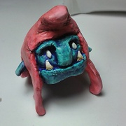 painted clay sculpture of a trolls head