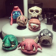 7 small painted clay sculptures including goblins a skeleton and a cyclops