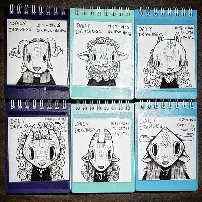 Photo of small notepads full of daily drawings